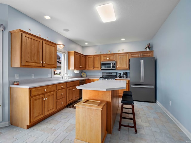 1106 Woodland Xing, Fort Wayne, IN 46825 - kitchen with appliances with stainless steel finishes, a kitchen island, light countertops, a kitchen breakfast bar, and recessed lighting