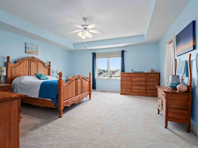 1106 Woodland Xing, Fort Wayne, IN 46825 - bedroom featuring a tray ceiling, light carpet, and ceiling fan