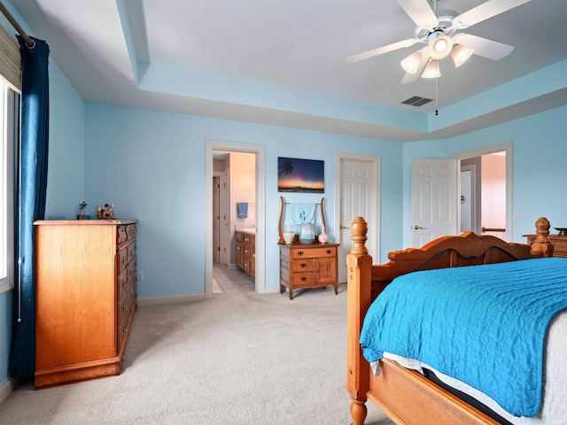 1106 Woodland Xing, Fort Wayne, IN 46825 - bedroom featuring light carpet, ensuite bathroom, a raised ceiling, and ceiling fan