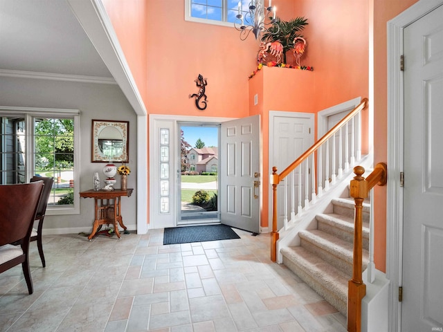 1106 Woodland Xing, Fort Wayne, IN 46825 - foyer with a chandelier, ornamental molding, stairway, a high ceiling, and light stone finish flooring