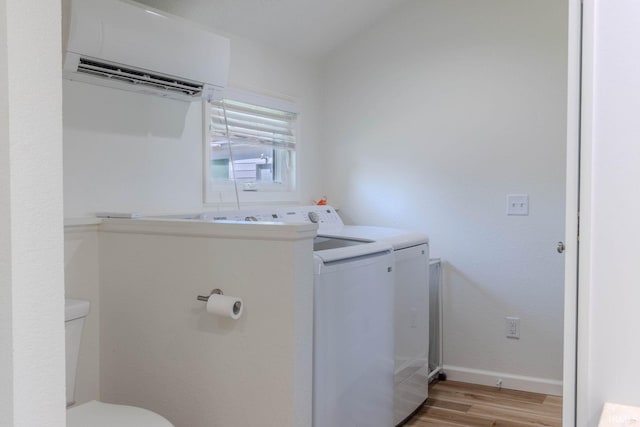 0175 Frantz Dr, Wawaka, IN 46794 - washroom with a wall mounted air conditioner, separate washer and dryer, and light wood finished floors