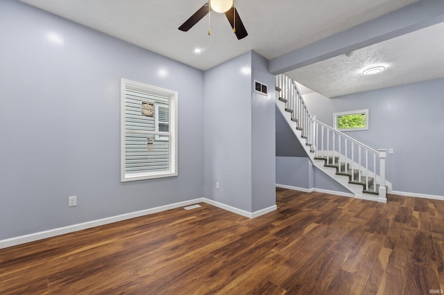 669 W Lexington Ave, Elkhart, IN 46514 - empty room with stairway, a ceiling fan, and wood finished floors