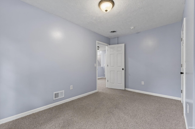 669 W Lexington Ave, Elkhart, IN 46514 - carpeted spare room featuring a textured ceiling and a smoke detector