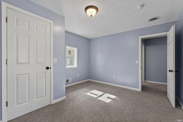 669 W Lexington Ave, Elkhart, IN 46514 - unfurnished bedroom with carpet flooring and a textured ceiling