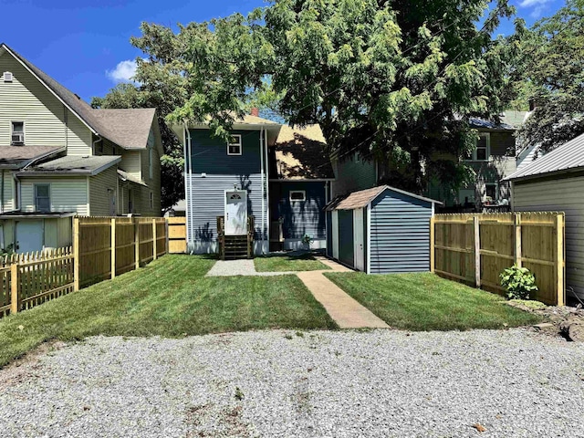 669 W Lexington Ave, Elkhart, IN 46514 - rear view of house featuring entry steps, a shed, and a fenced backyard
