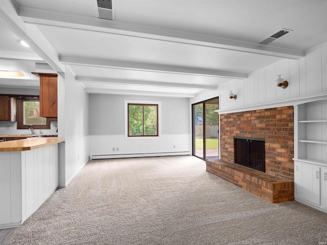 6506 Woodthrush Dr, Fort Wayne, IN 46835 - unfurnished living room featuring beamed ceiling, carpet, baseboard heating, a brick fireplace, and wainscoting