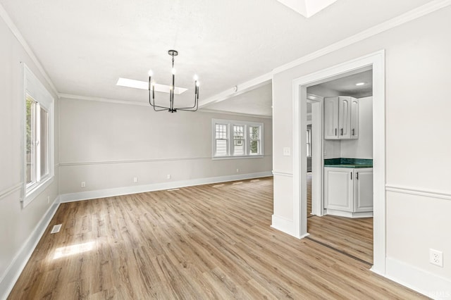 533 Altgeld St, South Bend, IN 46614 - unfurnished room with a chandelier, ornamental molding, light wood-style floors, and a skylight