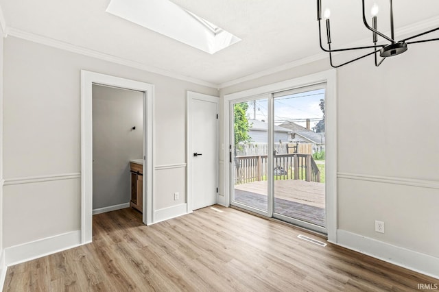533 Altgeld St, South Bend, IN 46614 - unfurnished dining area featuring ornamental molding, wood finished floors, a skylight, and a chandelier