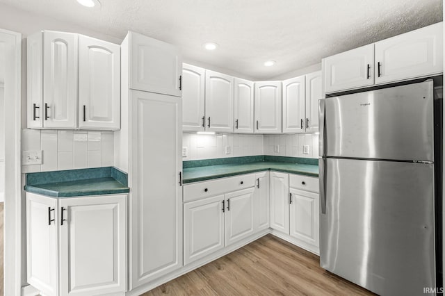 533 Altgeld St, South Bend, IN 46614 - kitchen featuring freestanding refrigerator, dark countertops, white cabinets, backsplash, and recessed lighting