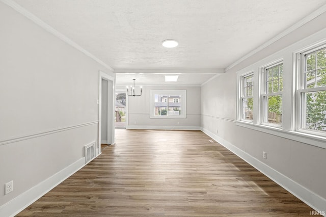533 Altgeld St, South Bend, IN 46614 - unfurnished room featuring healthy amount of natural light, crown molding, a chandelier, a textured ceiling, and wood finished floors