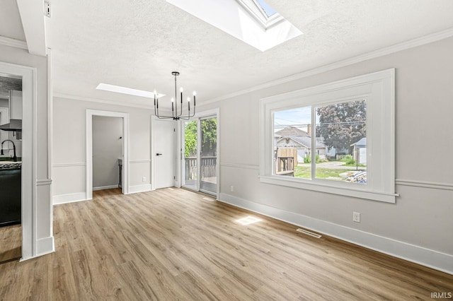 533 Altgeld St, South Bend, IN 46614 - unfurnished dining area featuring a skylight, a textured ceiling, light wood-style floors, ornamental molding, and a chandelier