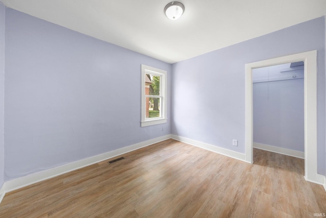 3014 Drexel Ave, Fort Wayne, IN 46806 - unfurnished bedroom with light wood-style floors, a closet, and a walk in closet