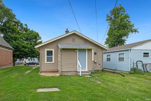 3014 Drexel Ave, Fort Wayne, IN 46806 - rear view of house with entry steps and a lawn