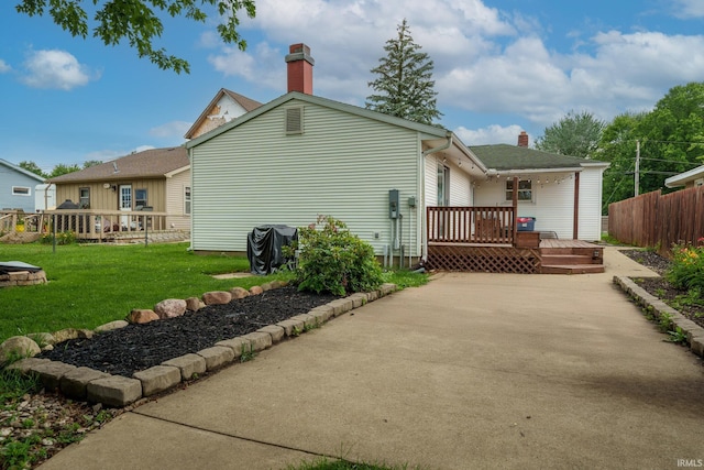 1712 Royal Center Pike, Logansport, IN 46947 - rear view of house featuring a chimney and a wooden deck
