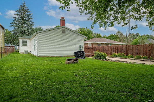 1712 Royal Center Pike, Logansport, IN 46947 - rear view of property featuring a fire pit, a fenced backyard, and a chimney