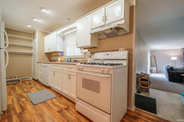 1712 Royal Center Pike, Logansport, IN 46947 - kitchen with white appliances, under cabinet range hood, white cabinets, crown molding, and light wood finished floors