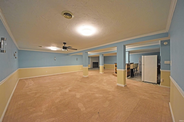 9818 Houndshill Pl, Fort Wayne, IN 46804 - finished below grade area with freestanding refrigerator, ornamental molding, a textured ceiling, carpet floors, and ceiling fan
