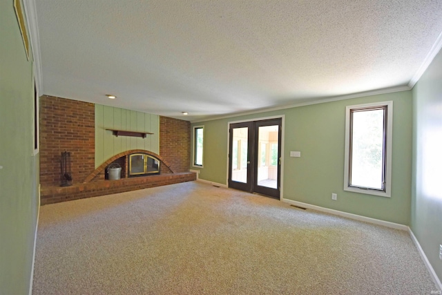 9818 Houndshill Pl, Fort Wayne, IN 46804 - unfurnished living room featuring a brick fireplace, a textured ceiling, plenty of natural light, carpet, and ornamental molding