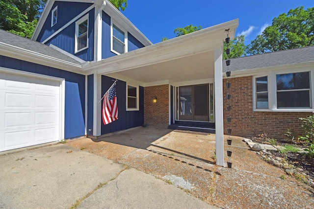 9818 Houndshill Pl, Fort Wayne, IN 46804 - property entrance with brick siding, concrete driveway, and a garage