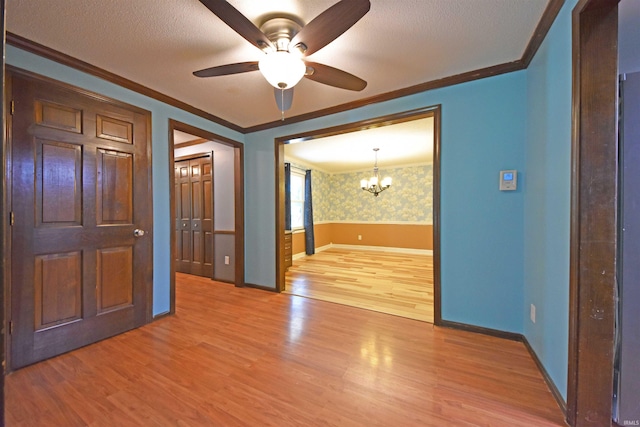 9818 Houndshill Pl, Fort Wayne, IN 46804 - empty room with ornamental molding, light wood-style floors, a chandelier, ceiling fan, and wallpapered walls