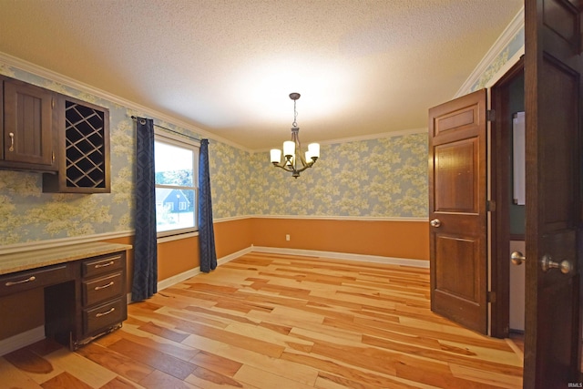 9818 Houndshill Pl, Fort Wayne, IN 46804 - unfurnished dining area with crown molding, light wood-style floors, a chandelier, wallpapered walls, and a textured ceiling