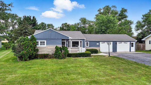 58 W Markle Rd, Huntington, IN 46750 - view of front facade featuring asphalt driveway, a garage, board and batten siding, and stone siding