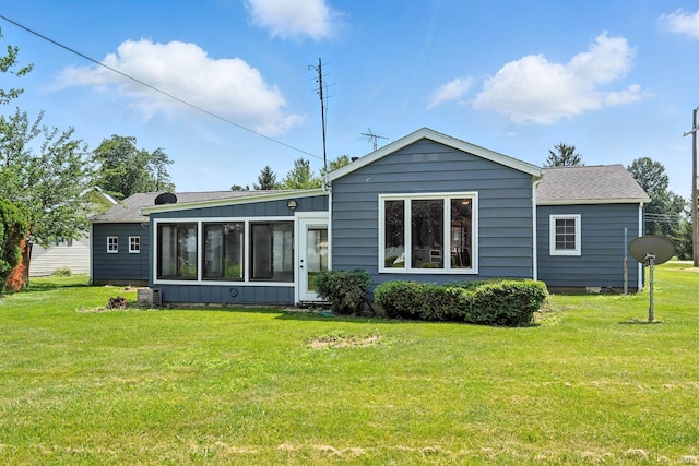 58 W Markle Rd, Huntington, IN 46750 - back of house featuring a lawn, a sunroom, and roof with shingles