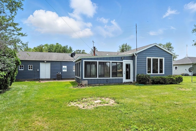 58 W Markle Rd, Huntington, IN 46750 - back of property featuring a sunroom, a lawn, and board and batten siding