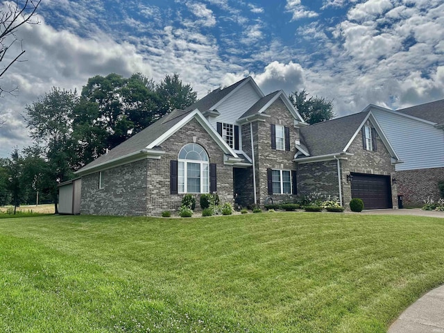 2939 Charlestown Ct, Evansville, IN 47725 - view of front facade with concrete driveway, brick siding, and a front yard