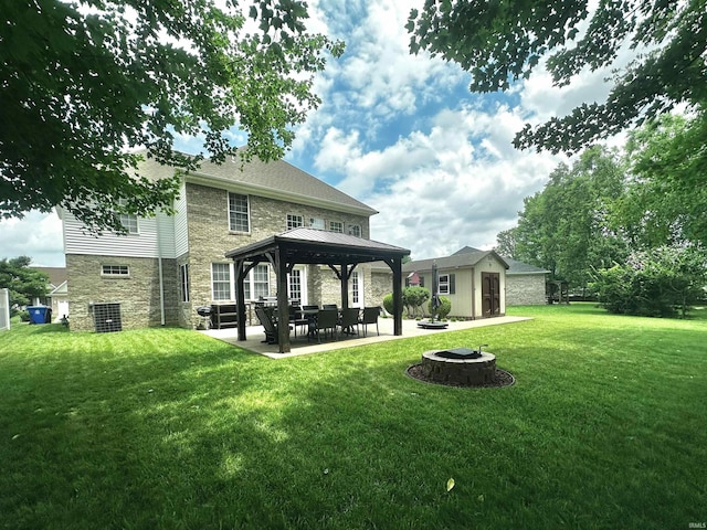 2939 Charlestown Ct, Evansville, IN 47725 - back of property featuring stone siding, a fire pit, a gazebo, a yard, and an outdoor structure