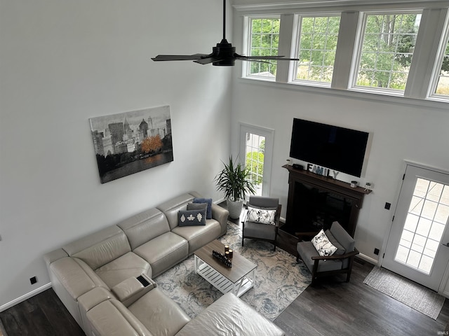 2939 Charlestown Ct, Evansville, IN 47725 - living area featuring a ceiling fan, plenty of natural light, wood finished floors, a fireplace, and a towering ceiling