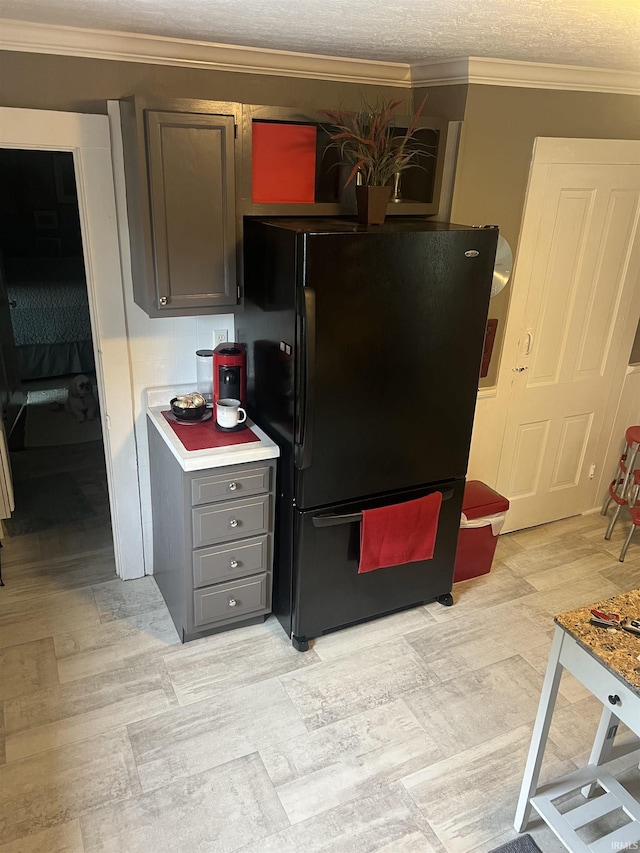 606 S S 10th St, Lafayette, IN 47905 - kitchen with freestanding refrigerator, gray cabinetry, ornamental molding, and light countertops