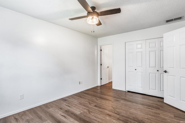 606 Larch Ln, Fort Wayne, IN 46825 - unfurnished bedroom with wood finished floors, a closet, a textured ceiling, and a ceiling fan