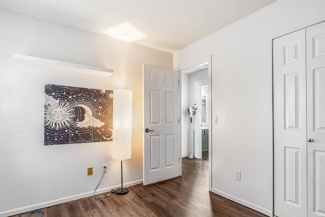 606 Larch Ln, Fort Wayne, IN 46825 - unfurnished bedroom with wood finished floors, a textured ceiling, and a closet