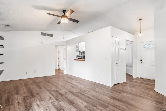 606 Larch Ln, Fort Wayne, IN 46825 - unfurnished living room with lofted ceiling, a ceiling fan, and wood finished floors