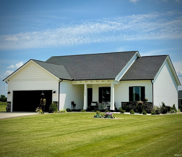 12788 Kingfish Ct, Middlebury, IN 46540 - view of front of property with a garage, a front yard, stone siding, and concrete driveway