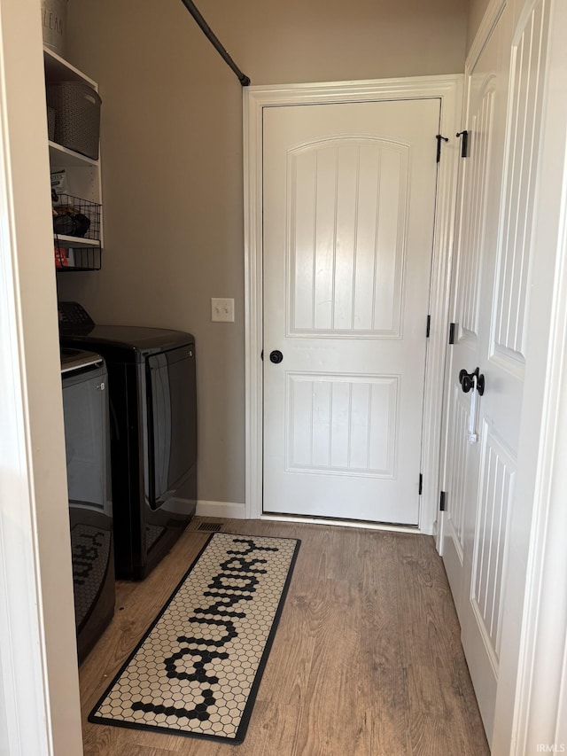 12788 Kingfish Ct, Middlebury, IN 46540 - laundry room featuring washer and dryer and wood finished floors