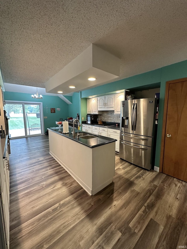 1701 Fairway Dr, Kokomo, IN 46901 - kitchen with stainless steel fridge, a textured ceiling, dark countertops, white cabinetry, and a chandelier