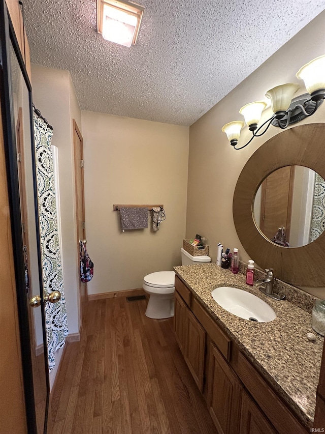 1701 Fairway Dr, Kokomo, IN 46901 - bathroom with wood finished floors, vanity, and a textured ceiling