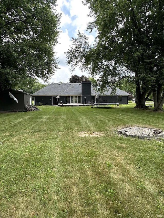 1701 Fairway Dr, Kokomo, IN 46901 - view of grassy yard featuring a trampoline