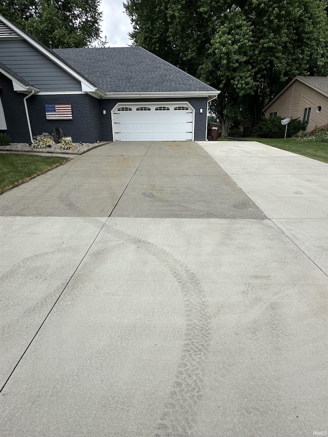 1701 Fairway Dr, Kokomo, IN 46901 - view of side of property featuring driveway, a garage, and brick siding