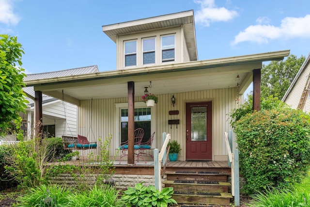 306 E Market St, Bluffton, IN 46714 - property entrance featuring covered porch and board and batten siding