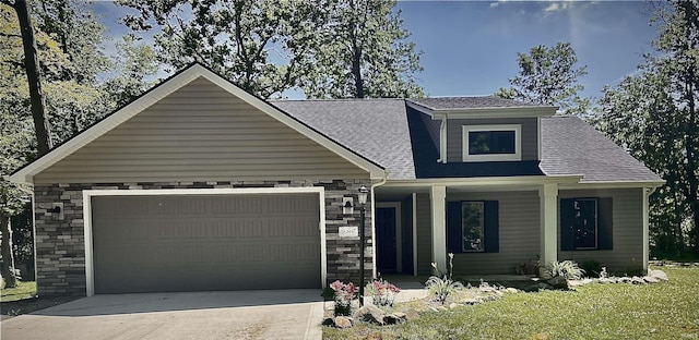 16807 Darling Rd, Woodburn, IN 46797 - view of front of property featuring a porch, stone siding, a garage, and driveway