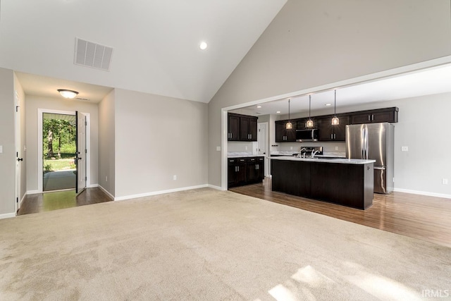 16807 Darling Rd, Woodburn, IN 46797 - kitchen featuring stainless steel appliances, carpet flooring, light countertops, open floor plan, and recessed lighting