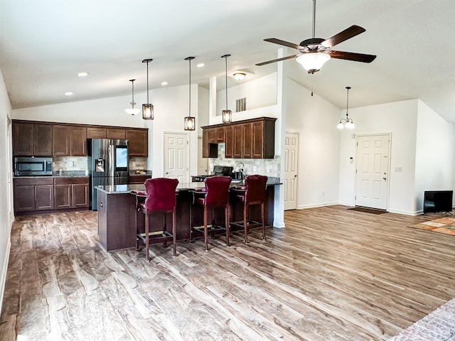6133 E 800 N Rd, Denver, IN 46926 - kitchen featuring appliances with stainless steel finishes, backsplash, dark brown cabinetry, recessed lighting, and high vaulted ceiling