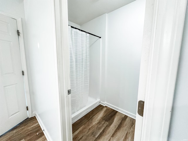 6133 E 800 N Rd, Denver, IN 46926 - full bathroom with wood finished floors and a shower with shower curtain