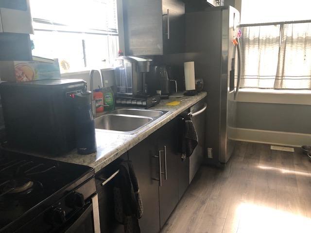 1124 N Maple St, Richland, IN 47634 - kitchen with light wood-style flooring, black range with electric cooktop, and light countertops