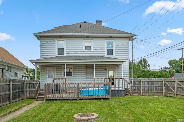 1234 Summit St, New Haven, IN 46774 - rear view of property featuring an outdoor fire pit, a fenced backyard, a shingled roof, and a chimney