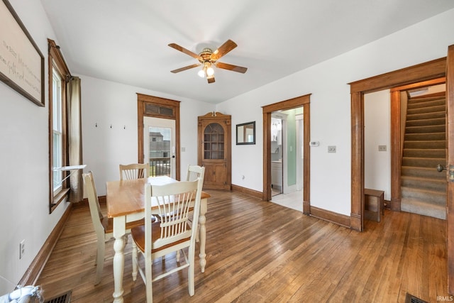 1234 Summit St, New Haven, IN 46774 - dining area featuring a ceiling fan, light wood finished floors, stairway, and healthy amount of natural light