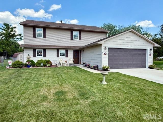 9910 Quachita Ct, Fort Wayne, IN 46804 - view of front of home featuring a garage, driveway, and a front yard